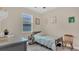 Inviting bedroom with neutral tones, a single bed, a desk, and a chair with lots of natural light at 4009 Swan Goose Ct, Okahumpka, FL 34762