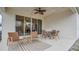 Relaxing covered patio with comfortable seating, perfect for enjoying outdoor living and dining at 4009 Swan Goose Ct, Okahumpka, FL 34762