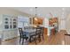 Well-lit dining area adjacent to an open kitchen with a modern hutch and table at 4009 Swan Goose Ct, Okahumpka, FL 34762