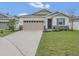 Charming single-story home with a well-manicured lawn and a two-car garage at 4009 Swan Goose Ct, Okahumpka, FL 34762