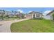 Inviting curb appeal with a well-maintained lawn and a view of the neighborhood at 4009 Swan Goose Ct, Okahumpka, FL 34762