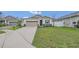 Charming one-story home with a well-manicured lawn and a two-car garage at 4009 Swan Goose Ct, Okahumpka, FL 34762