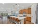 Open concept kitchen featuring a large island, stainless steel appliances, and breakfast bar seating at 4009 Swan Goose Ct, Okahumpka, FL 34762
