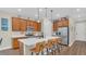Spacious kitchen with stainless steel appliances and large center island with bar stools at 4009 Swan Goose Ct, Okahumpka, FL 34762
