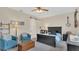 Calm main bedroom with two chairs, a bed, ceiling fan, and chest with neutral tones at 4009 Swan Goose Ct, Okahumpka, FL 34762