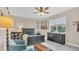 Serene main bedroom with a dark wood bed set, ceiling fan, and large window at 4009 Swan Goose Ct, Okahumpka, FL 34762