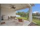 Covered patio with a ceiling fan, lights, outdoor furniture, a grill, and views of the pond at 4009 Swan Goose Ct, Okahumpka, FL 34762