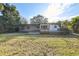 The back of the house features a fenced backyard with a wooden deck and a screened in porch at 4249 Kendrick Rd, Orlando, FL 32804