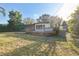 The back of the house features a fenced backyard with a wooden deck and a screened in porch at 4249 Kendrick Rd, Orlando, FL 32804