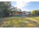 The back of this house features a fenced backyard with a wooden deck and a screened in porch at 4249 Kendrick Rd, Orlando, FL 32804