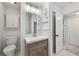 Bathroom with wood vanity, white countertop, toilet, and glass-enclosed shower at 4249 Kendrick Rd, Orlando, FL 32804