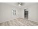 Bright bedroom showcasing wood-look flooring, window shutters, and a ceiling fan at 4249 Kendrick Rd, Orlando, FL 32804