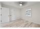 Bright, airy bedroom featuring whitewashed wood-look floors, a modern ceiling fan, and a window with shutters at 4249 Kendrick Rd, Orlando, FL 32804
