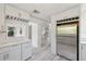 Bright kitchen featuring stainless steel refrigerator, white cabinets, and light wood-look flooring at 4249 Kendrick Rd, Orlando, FL 32804