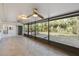 Screened-in lanai featuring views of lush backyard, tiled flooring, and access to the main house at 4249 Kendrick Rd, Orlando, FL 32804