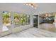 Enclosed lanai with views of lush greenery, tiled flooring, and multiple access points to the main house at 4249 Kendrick Rd, Orlando, FL 32804