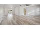 Bright living room with whitewashed wood-look floors and neutral tones, leading to outdoor living spaces at 4249 Kendrick Rd, Orlando, FL 32804
