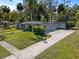Rear of the home with a large concrete driveway and mature landscaping at 430 S Virginia Ave, Sanford, FL 32771