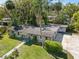 Aerial view of a single-story home with a large driveway and mature landscaping at 430 S Virginia Ave, Sanford, FL 32771