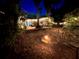Tranquil backyard with fire pit, seating, string lights and a hammock hanging from a tree at 430 S Virginia Ave, Sanford, FL 32771