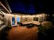 Outdoor living space with a wooden deck, comfortable seating, and warm lighting at night at 430 S Virginia Ave, Sanford, FL 32771