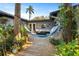 Inviting backyard deck with lounge seating, hammock, and lush tropical landscaping at 430 S Virginia Ave, Sanford, FL 32771
