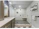 Bright bathroom featuring a glass shower, dual shower heads and black and white patterned tile at 430 S Virginia Ave, Sanford, FL 32771