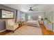 Comfortable bedroom with natural light, hardwood floors, and a cozy seating area for relaxation and style at 430 S Virginia Ave, Sanford, FL 32771
