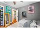 Bedroom with grey walls and wood floors, featuring unique artwork on the walls at 430 S Virginia Ave, Sanford, FL 32771