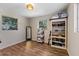 Bright bedroom with wood floors featuring shelving for storage and two windows for plenty of light at 430 S Virginia Ave, Sanford, FL 32771