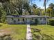 Well-maintained single story home with an inviting front lawn and mature trees at 430 S Virginia Ave, Sanford, FL 32771