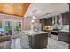 Modern kitchen featuring custom cabinets, stainless appliances, and a stylish island with seating for casual dining at 430 S Virginia Ave, Sanford, FL 32771