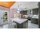Well-lit kitchen with marble countertops, stainless appliances, a kitchen island, and stylish pendant lighting at 430 S Virginia Ave, Sanford, FL 32771