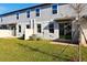Backyard features grass, a partial fence, and a small patio space outside of the sliding glass doors at 4332 Ranch House Rd, St Cloud, FL 34772