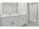 Modern bathroom featuring a double vanity and a glass-enclosed shower with tiled walls at 4332 Ranch House Rd, St Cloud, FL 34772