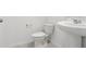 Bathroom with white toilet and pedestal sink, modern fixtures, and neutral color scheme at 4332 Ranch House Rd, St Cloud, FL 34772