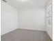 Bedroom with neutral carpet, white walls, and natural light from a window at 4332 Ranch House Rd, St Cloud, FL 34772
