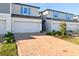 Charming townhome featuring a brick driveway, one-car garage and neat landscaping at 4332 Ranch House Rd, St Cloud, FL 34772