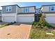 Charming townhome featuring a brick driveway, one-car garage and neat landscaping at 4332 Ranch House Rd, St Cloud, FL 34772