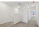 Upstairs hallway with carpet, white walls and trim, and natural light from a window at 4332 Ranch House Rd, St Cloud, FL 34772