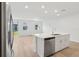 Kitchen island with stainless dishwasher and sink, lots of natural light, and stainless refrigerator at 4332 Ranch House Rd, St Cloud, FL 34772