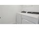 This laundry room comes with a full sized, white, Whirlpool washer and dryer and overhead storage at 4332 Ranch House Rd, St Cloud, FL 34772