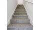 Carpeted stairs leading to the second floor, featuring white walls and handrail at 4332 Ranch House Rd, St Cloud, FL 34772
