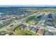 An aerial view of a suburban neighborhood featuring orderly rows of homes, a main street and lush green spaces at 4475 Casablanca Ave, Kissimmee, FL 34746