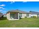 Expansive backyard featuring lush green grass and a covered patio for outdoor enjoyment at 4475 Casablanca Ave, Kissimmee, FL 34746