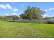 Green backyard with mature trees providing shade and privacy at 4475 Casablanca Ave, Kissimmee, FL 34746