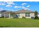 Lush backyard with a covered patio and well-manicured lawn, perfect for outdoor living at 4475 Casablanca Ave, Kissimmee, FL 34746