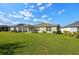 Spacious backyard featuring a covered patio, well-maintained lawn, and exterior of the home at 4475 Casablanca Ave, Kissimmee, FL 34746