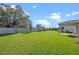 Expansive backyard with lush green grass, mature trees, and a privacy fence at 4475 Casablanca Ave, Kissimmee, FL 34746