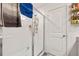 Tiled bathroom with glass-enclosed shower and convenient built-in shelving at 4475 Casablanca Ave, Kissimmee, FL 34746